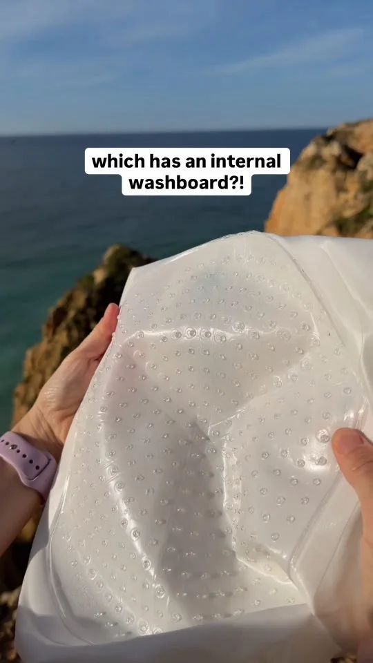 Lifestyle UGC: a travel wash bag held up by the sea