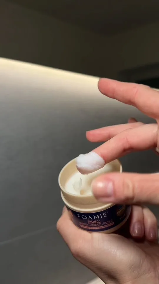The same video: a close-up of the Foamie hair cream jar